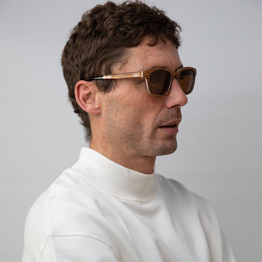 Man wearing  Eco conscious wooden sunglasses with light coloured wood facing sideways