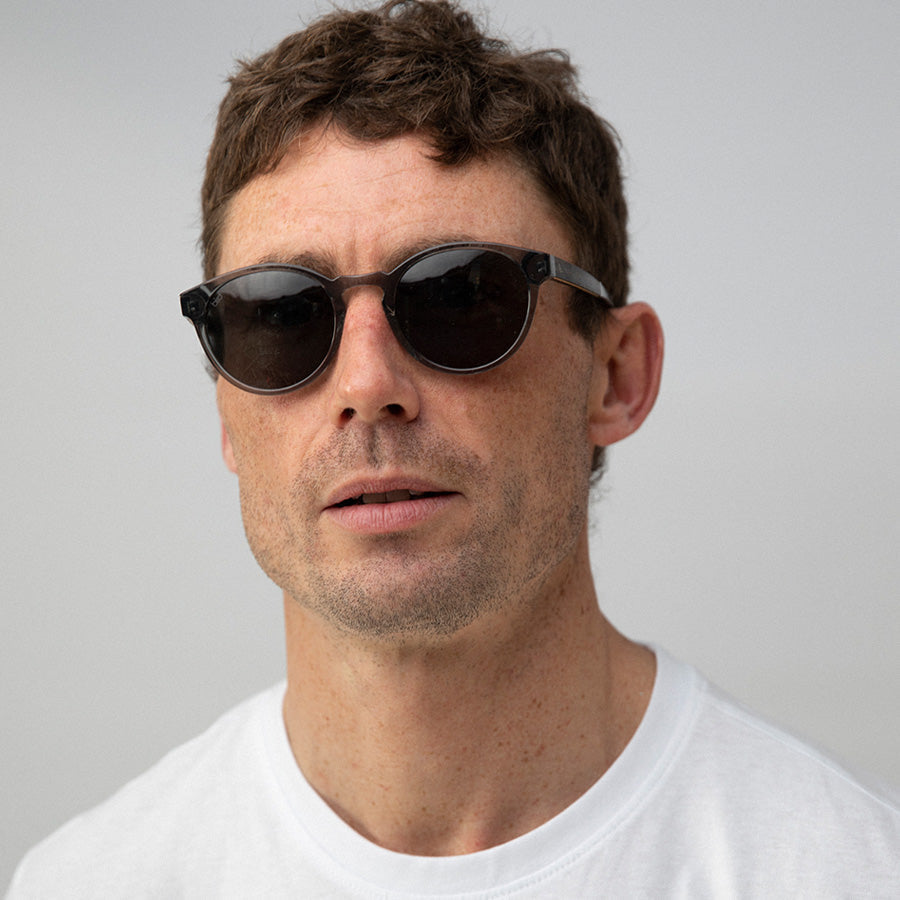 Man wearing clear grey frame sunglasses with polarised lenses